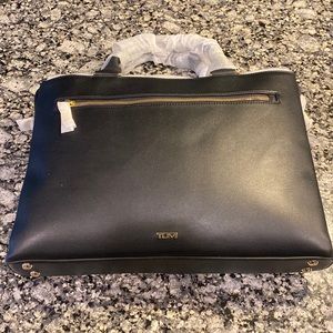 Brand new Tumi Cameron Business Brief, holds 15” laptop, room for extra items.